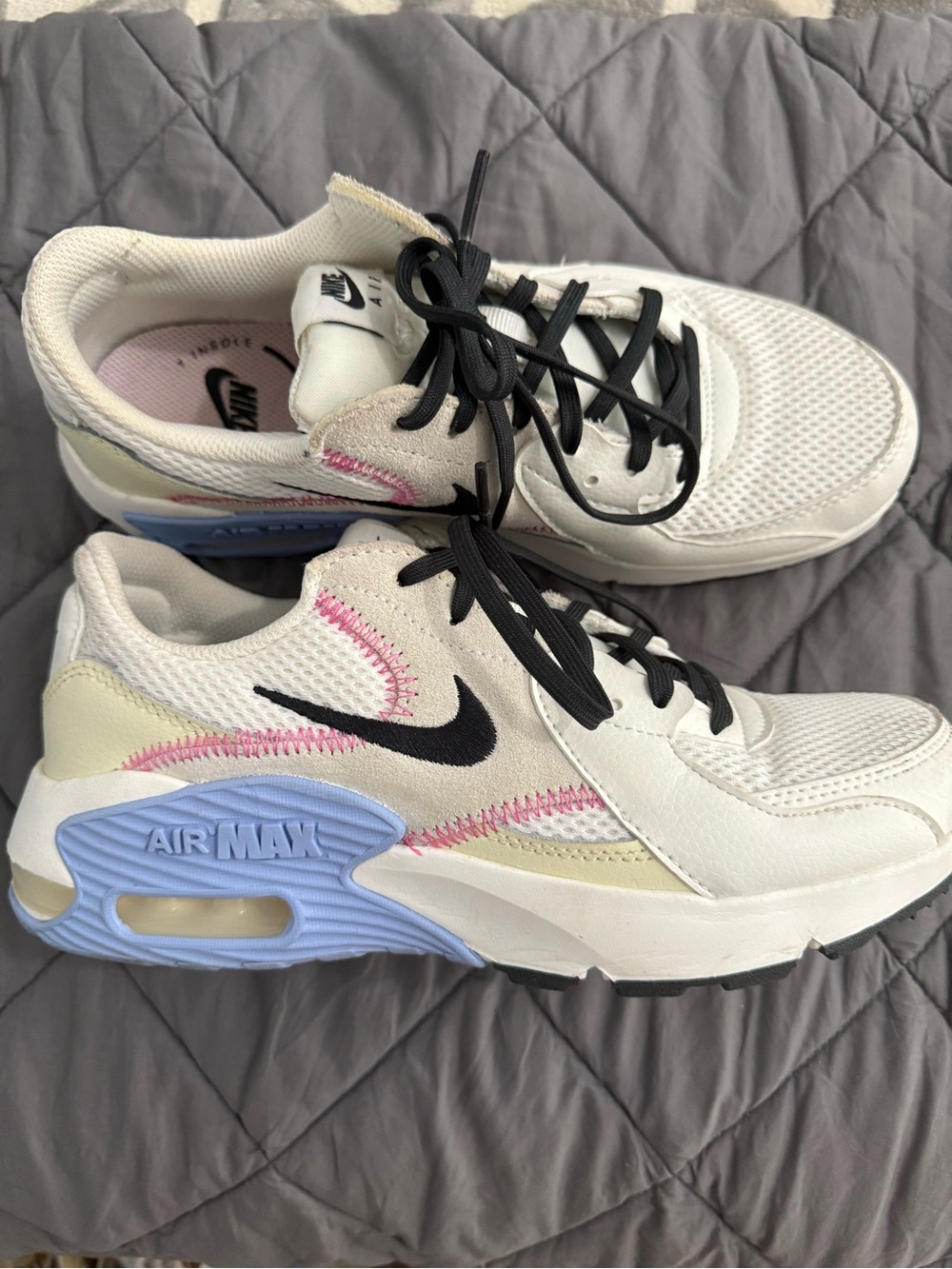 Nike White Air Max Sneakers with Black Swoosh and Pastel Blue & Pink Details